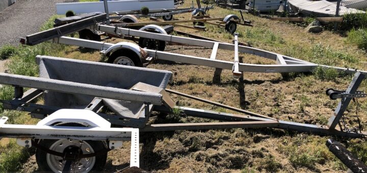 picture of empty boat trailers on the grass